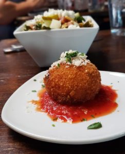 A white plate topped with food on top of wooden table.